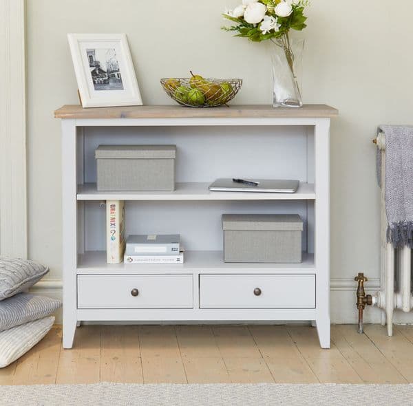 Signature Low BookcaseLow wide grey bookcase with two shelves and two storage drawers.